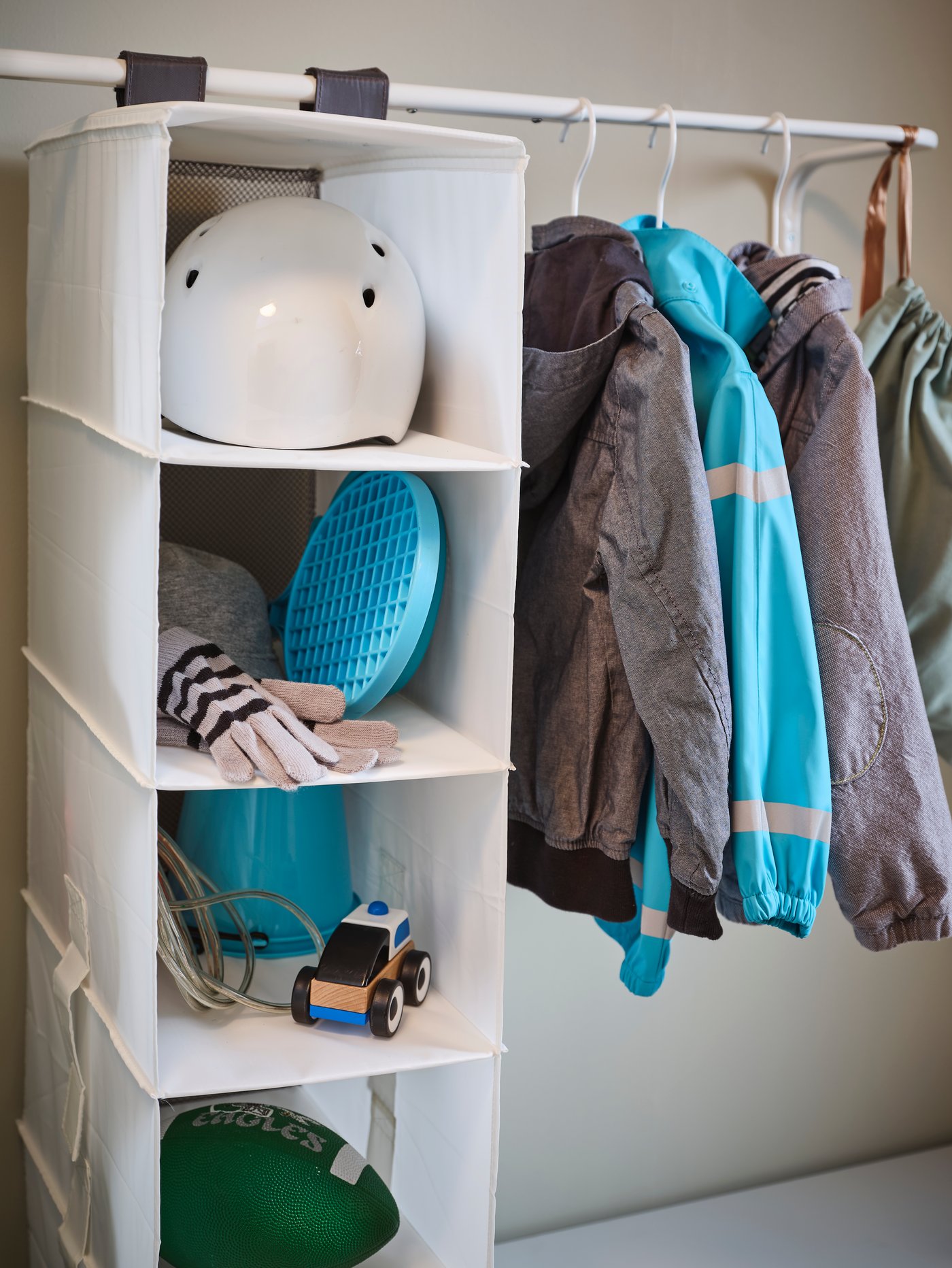 A white RASSLA storage with 5 compartments in the hallway