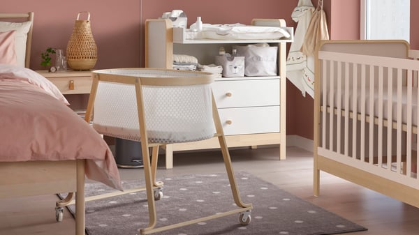 A birch/white ÄLSKVÄRD cot in a master bedroom