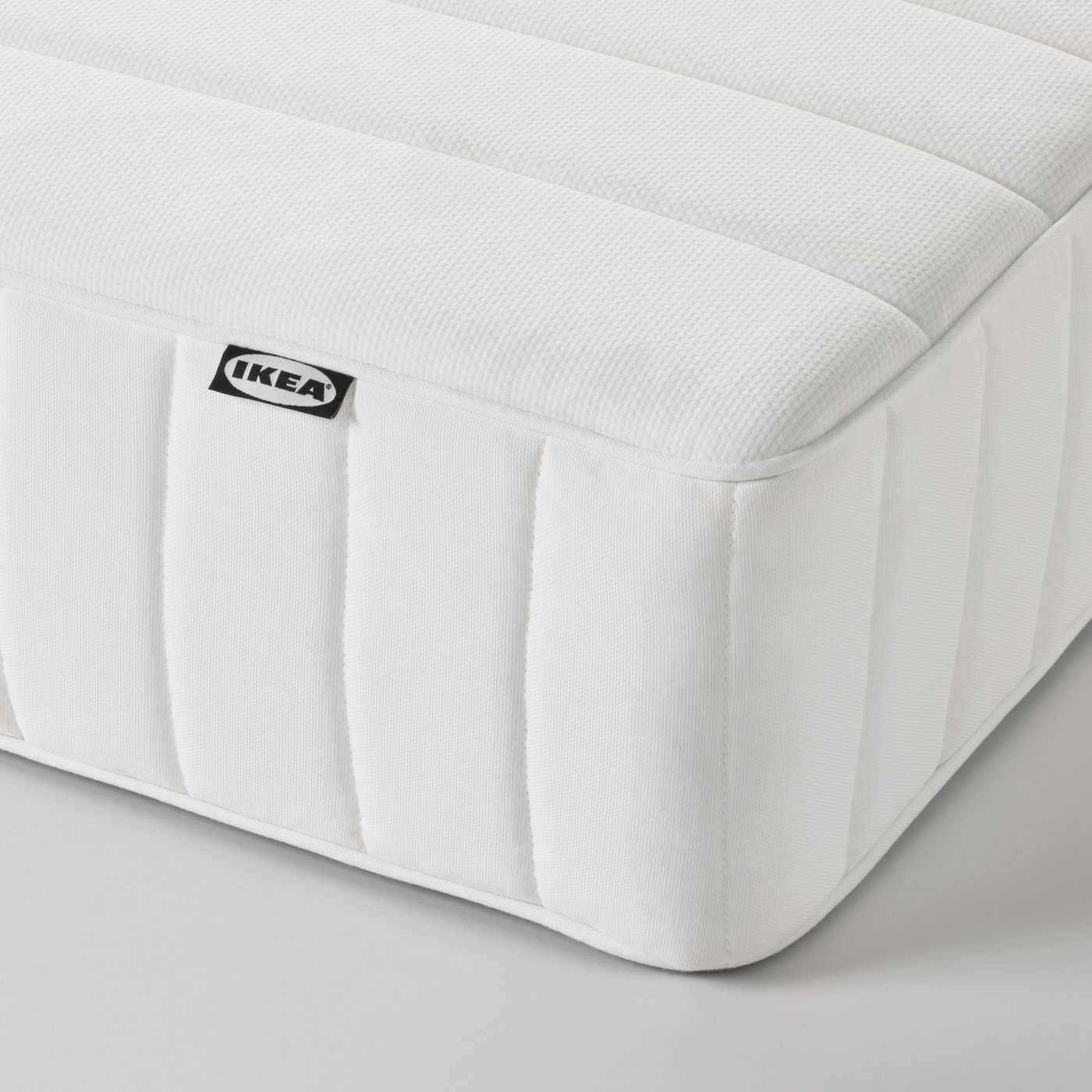 A firm/white VALEVÅG pocket sprung mattress