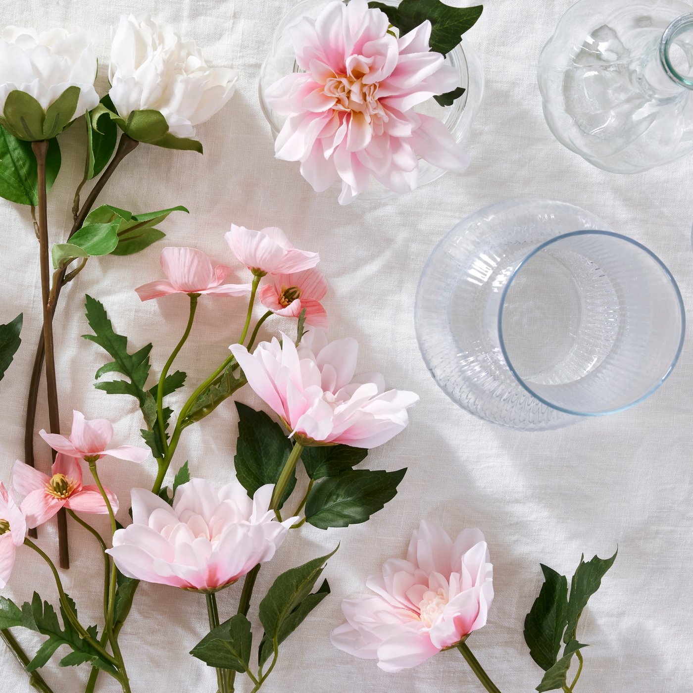 White peony SMYCKA artificial flowers and pink dahlia SMYCKA artificial flowers lie on a white surface.