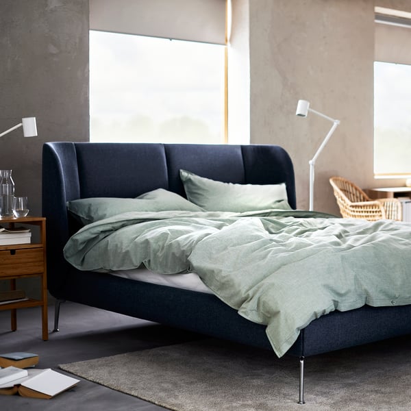 an upholstered, gray TUFJORD in a bright bedroom