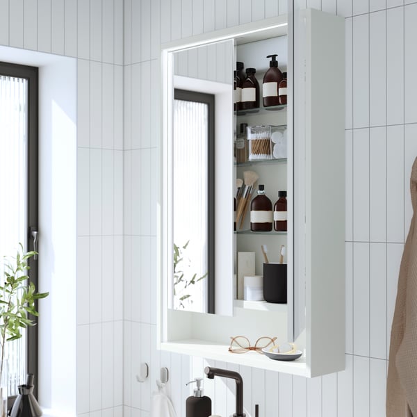 A white FAXÄLVEN mirror cabinet w built-in lighting