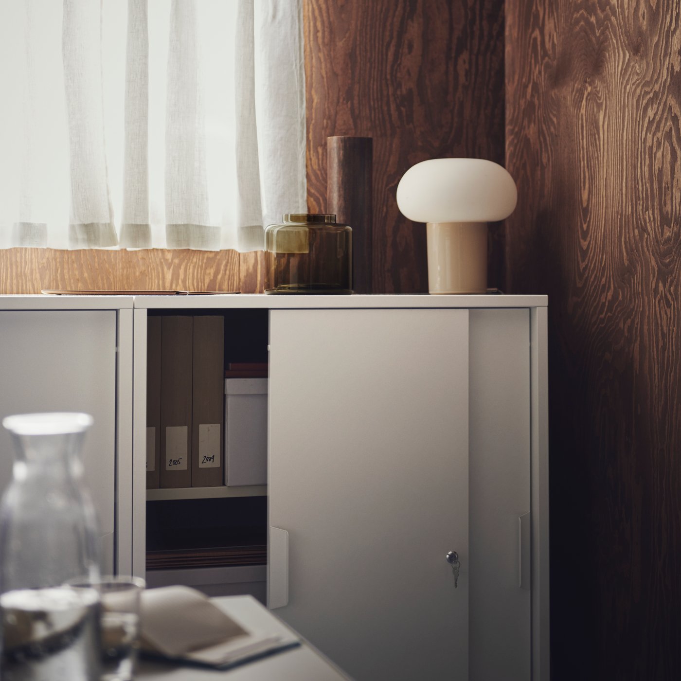 White cabinet with a lamp on top