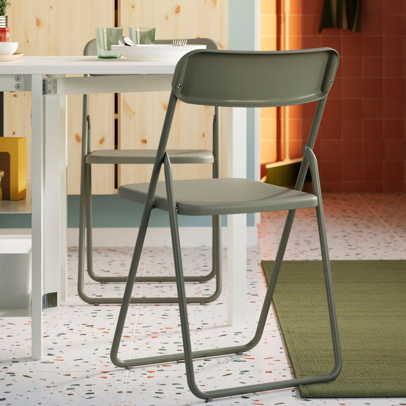 A green VIHALS folding chair