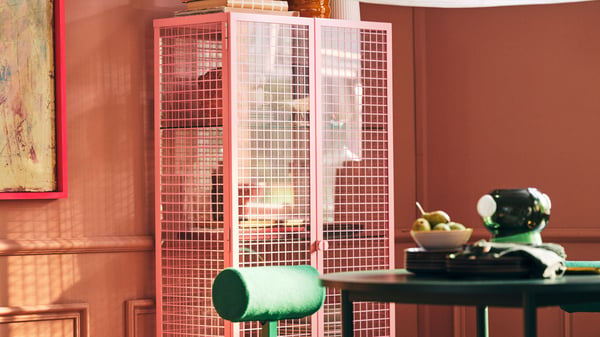 A light pink IKEA PS 2026 glass-door cabinet