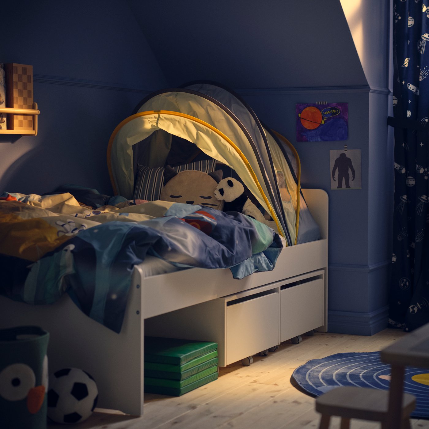 A green PLUFSIG folding gym mat in the childrens room