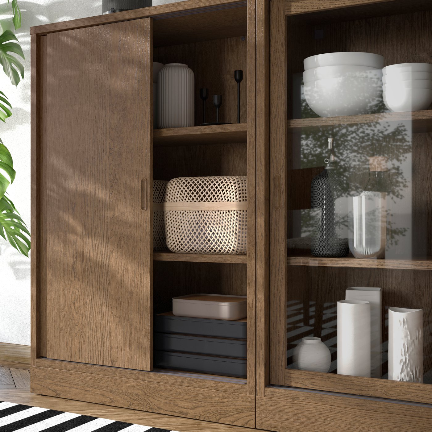 A brown stained oak veneer/clear glass TONSTAD storage combination w sliding doors in the dining room