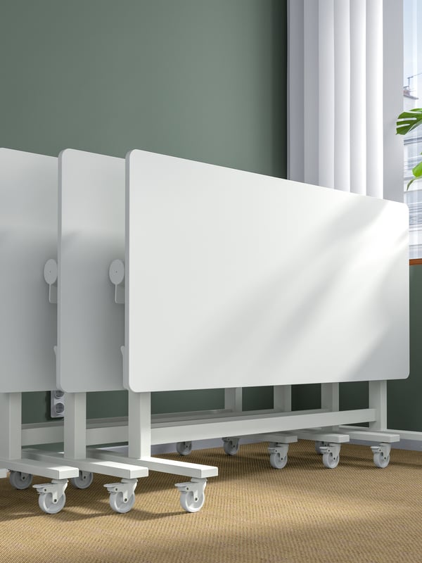 A white MITTZON foldable table with castors