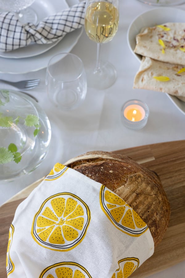 A loaf of bread with a lemon print tea towel