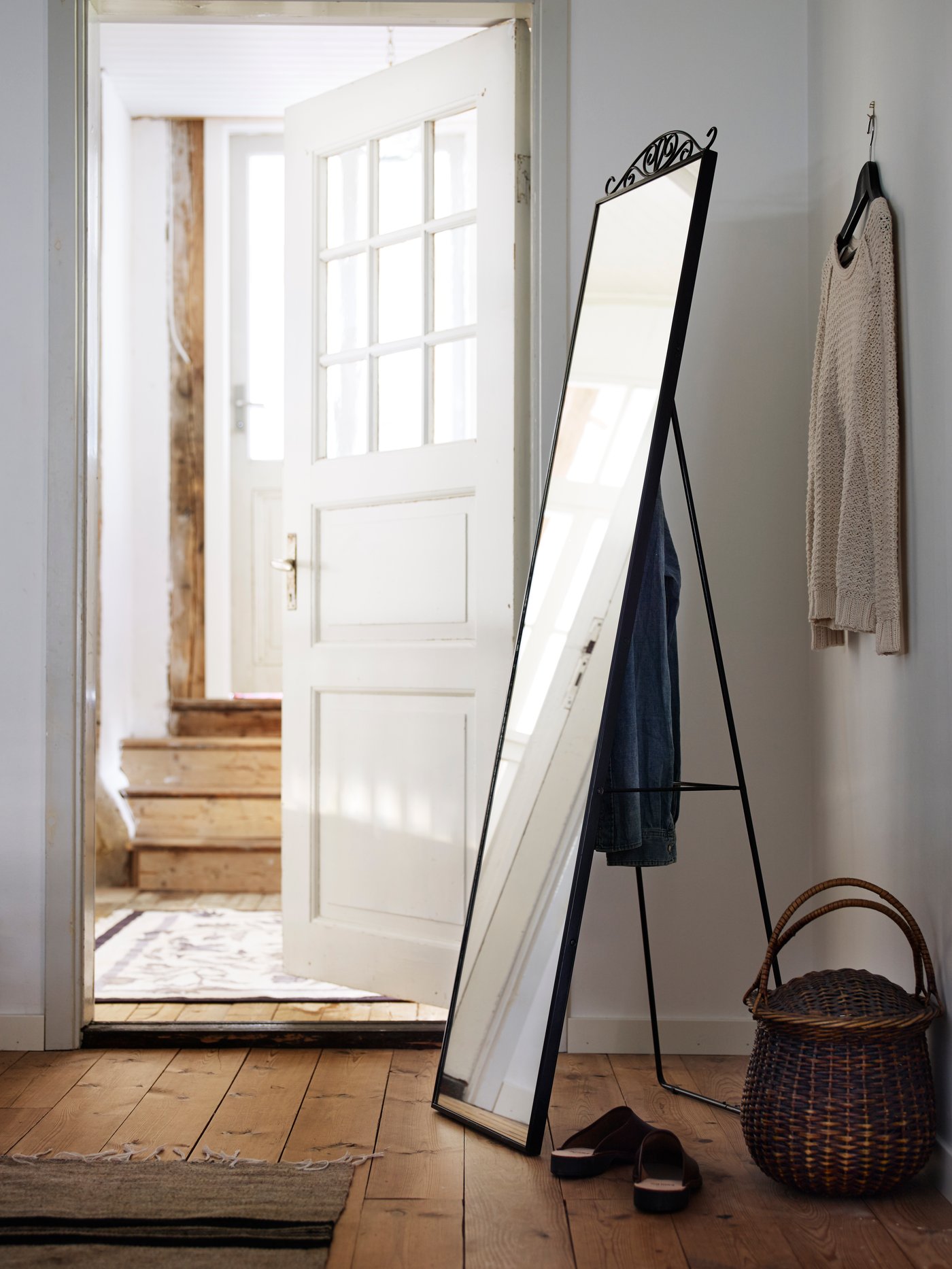 A black KARMSUND standing mirror