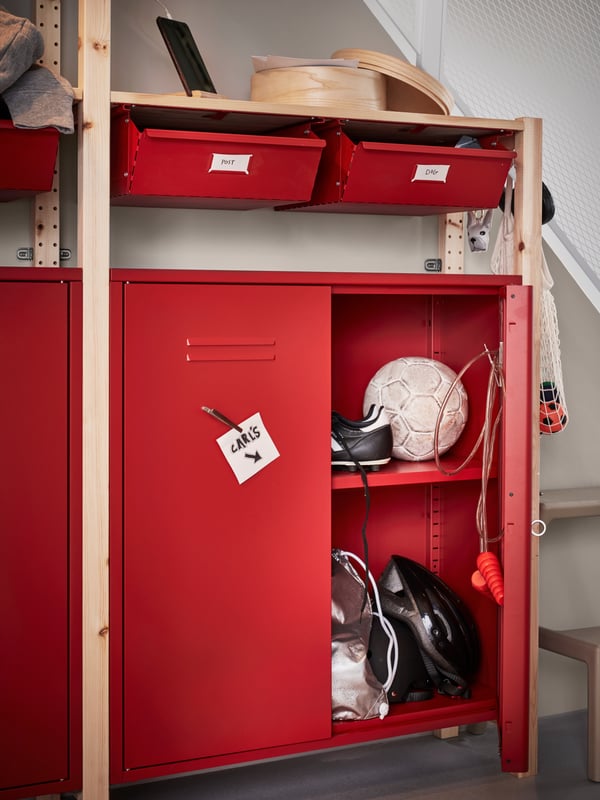 Bright red drawer and cabinet that fits the shelf with one of the cabinet door is opened.
