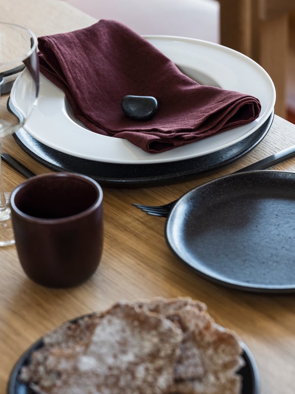 A dark red STOCKHOLM 2025 napkin