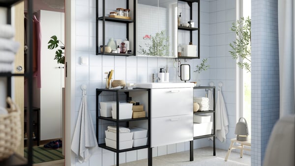 A bathroom with an ENHET bathroom set including a base cabinet for wash-basin with 2 drawers and open frames with shelves.