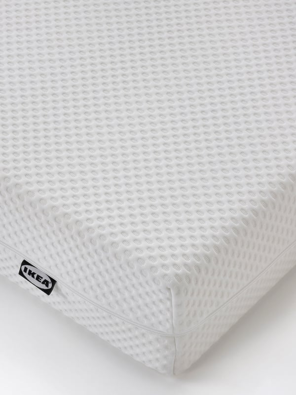 A firm/white ÅBYGDA foam mattress