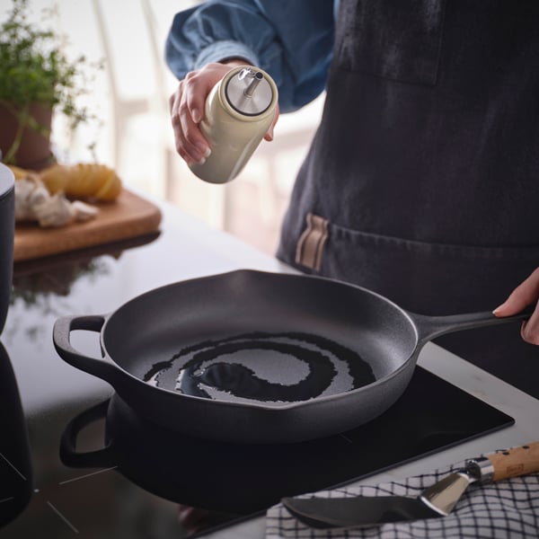 A beige BRUGDHAJ oil/vinegar bottle
