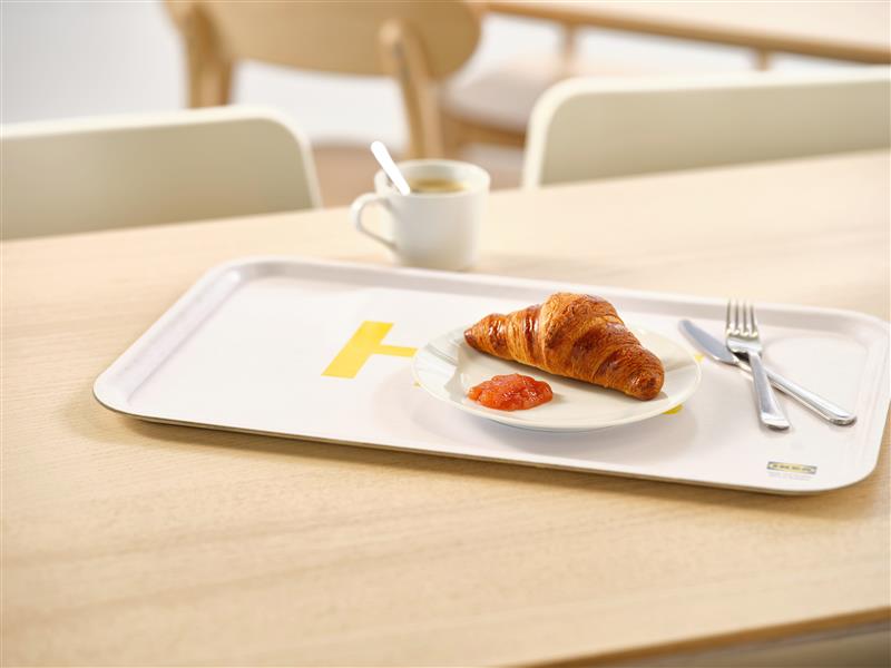 IKEA breakfast with a butter croissant and jam on a white tray.