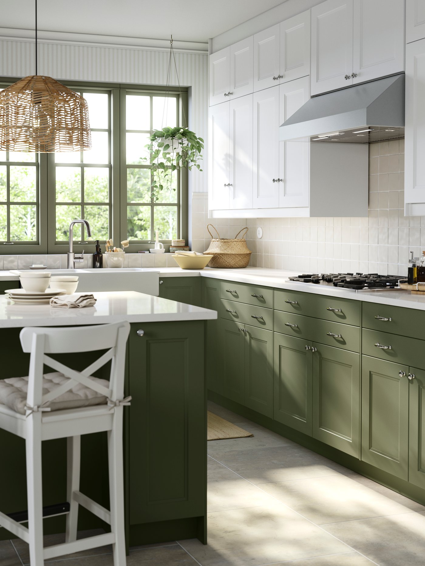 A kitchen with a large window has cabinets with grey-green and white AXSTAD fronts and a kitchen island with seating.