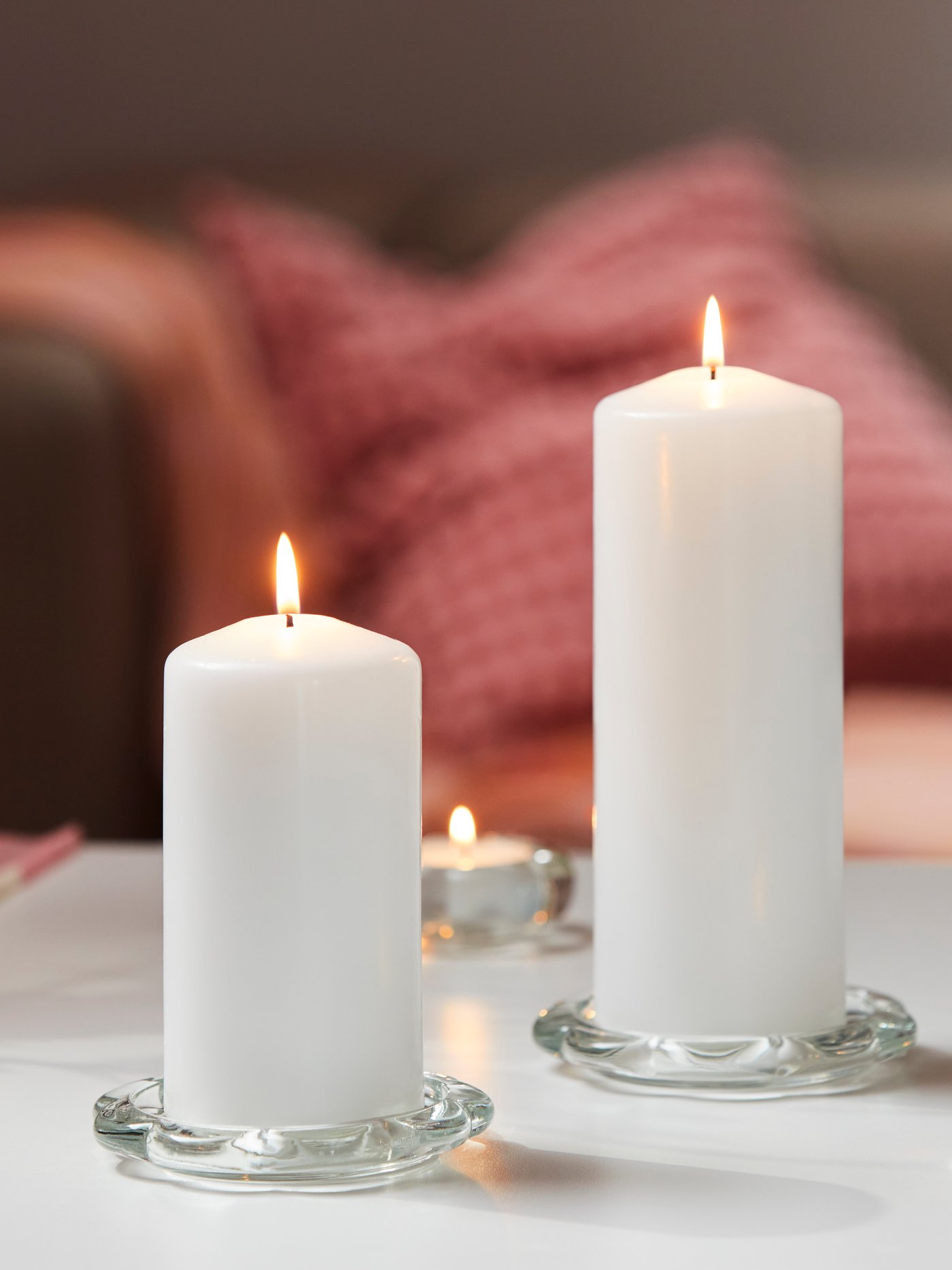 A white FENOMEN unscented pillar candle