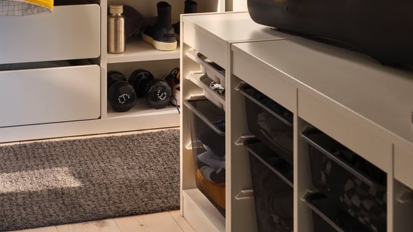 A dark grey TROFAST mesh storage box