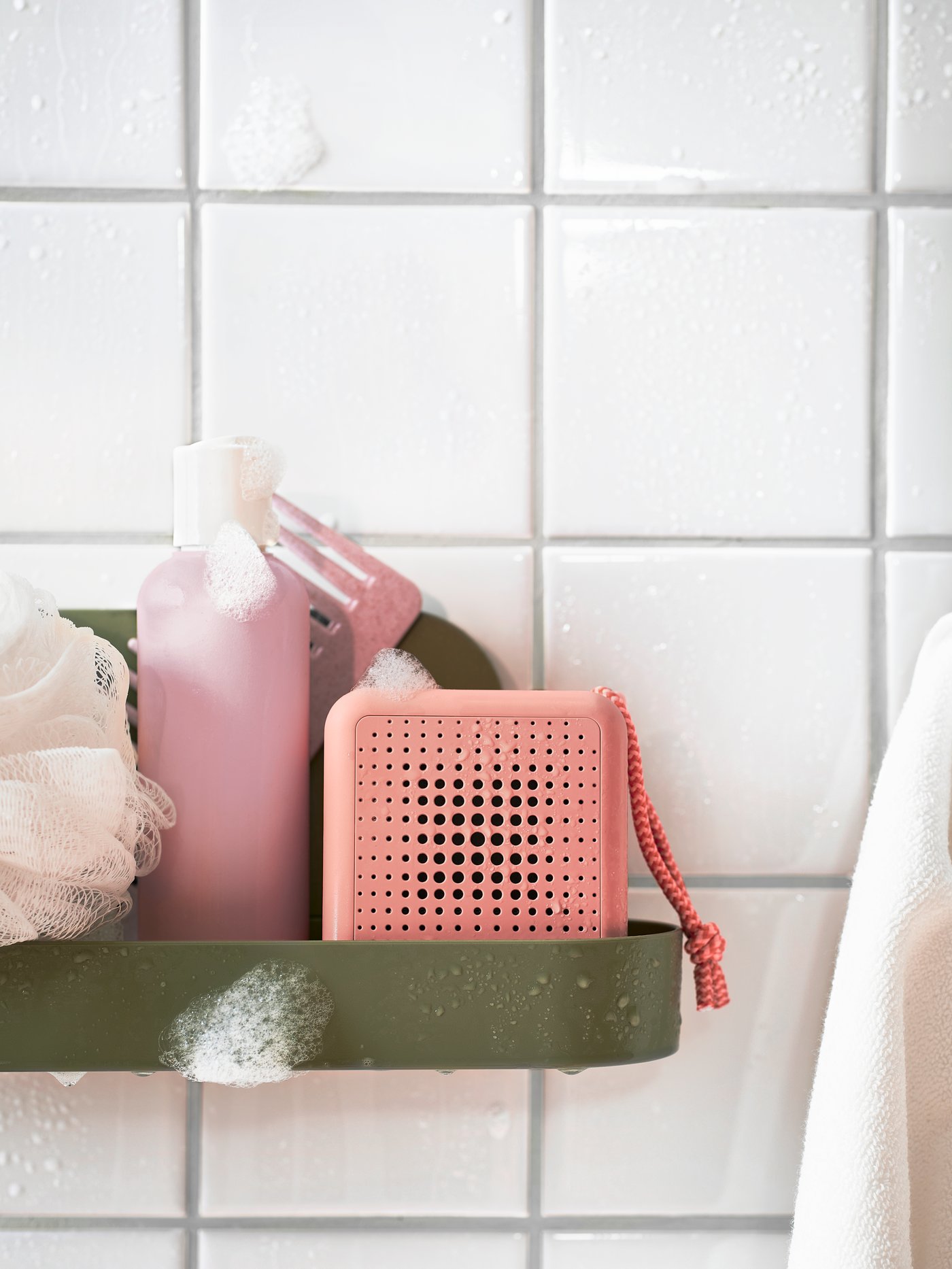 Shower products covered in soap sitting on a shelf inside the shower