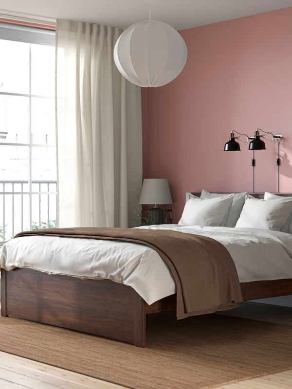 A brown SONGESAND bed frame