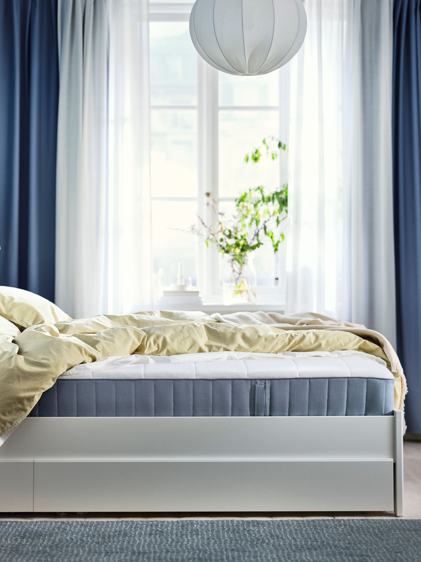 An extra firm/light blue VESTERÖY pocket sprung mattress in the bedroom