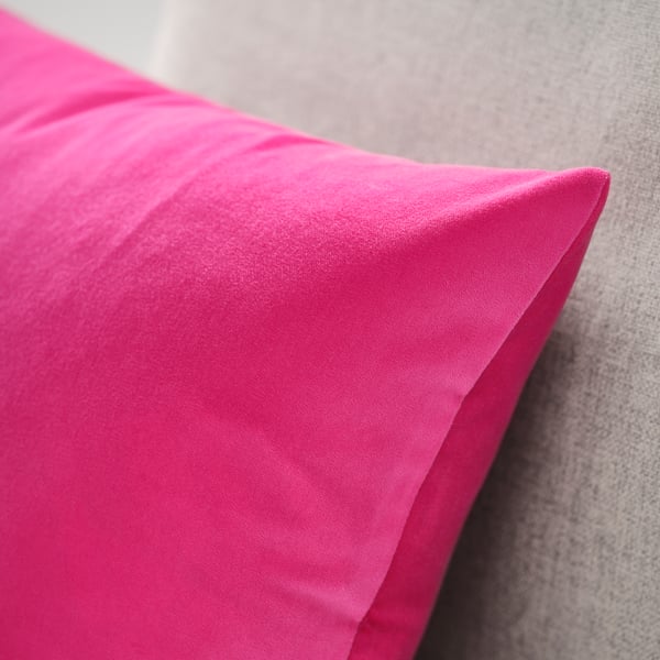 A bright pink SANELA cushion cover