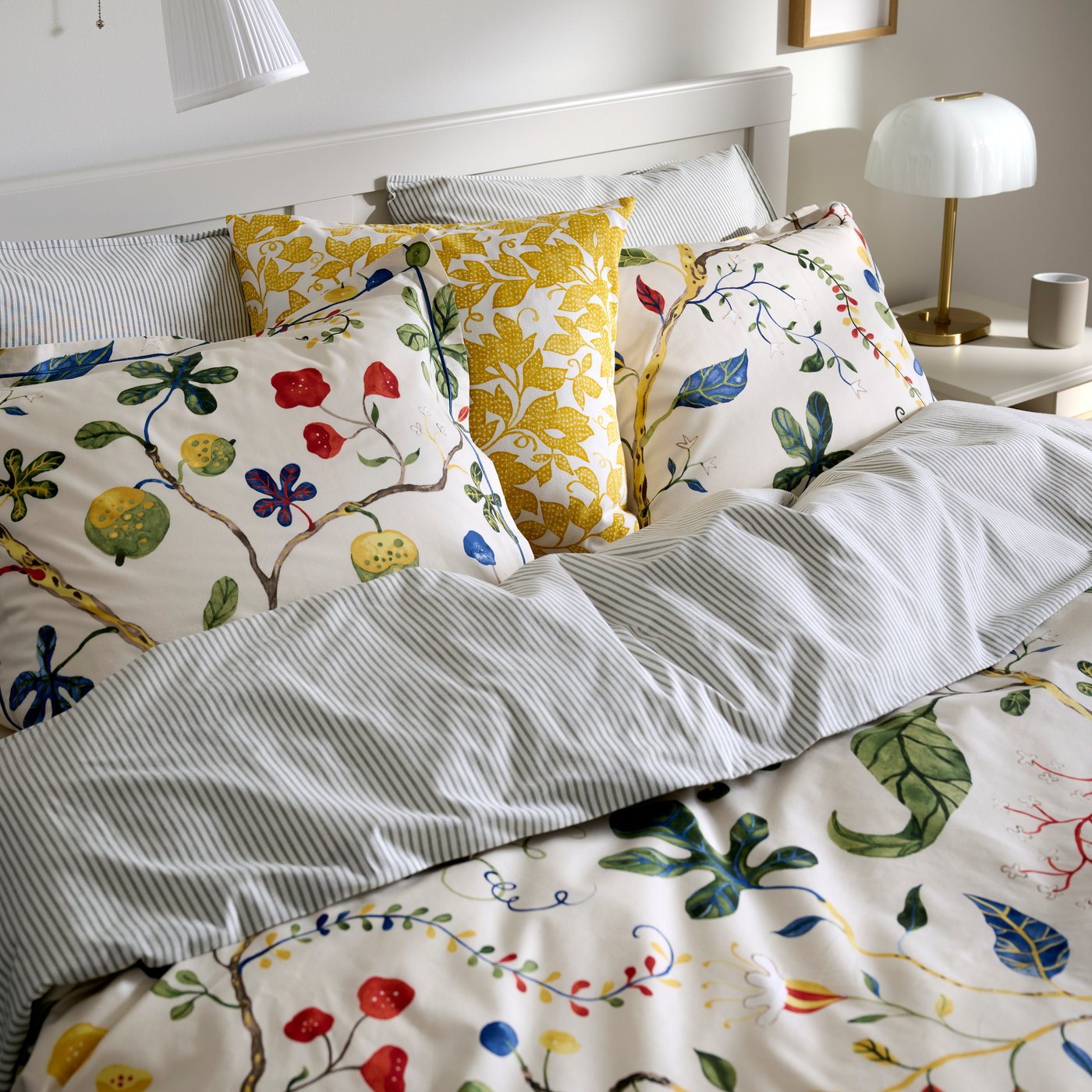 A close up of a bed with floral KRONBUSKE duvet cover.