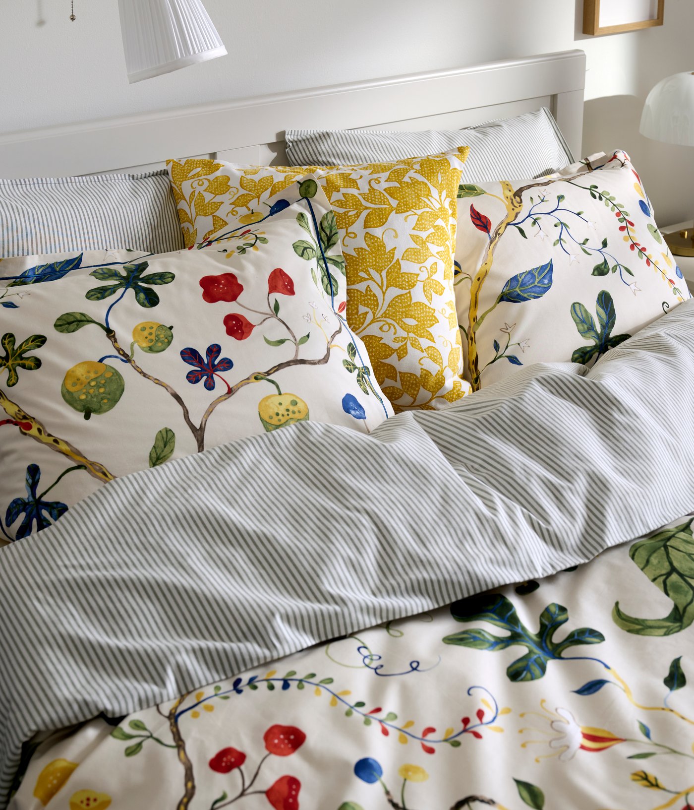 A close up of a bed with floral KRONBUSKE duvet cover.