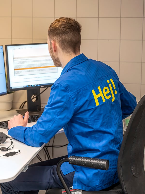 An IKEA co-worker working at a computer.