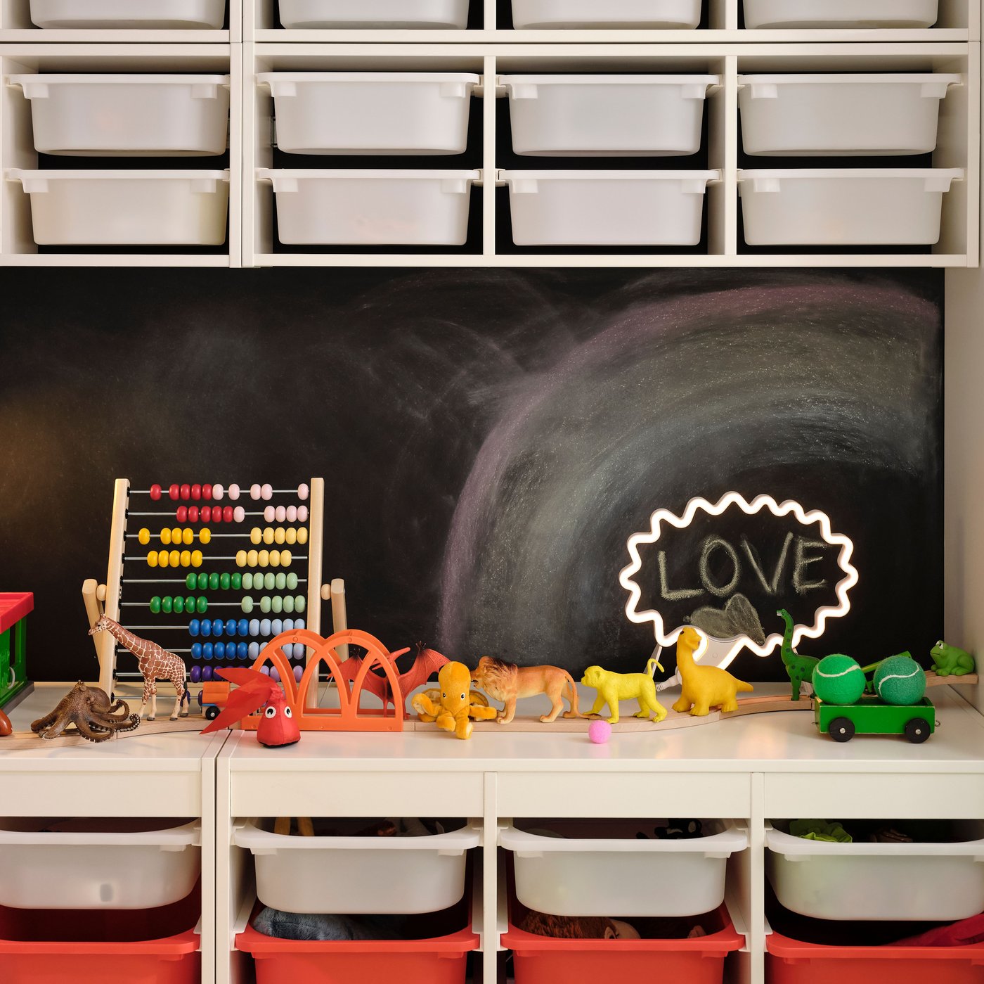 Two TROFAST storage combinations with boxes against a black wall. Four TROFAST wall storage with white boxes are above them.