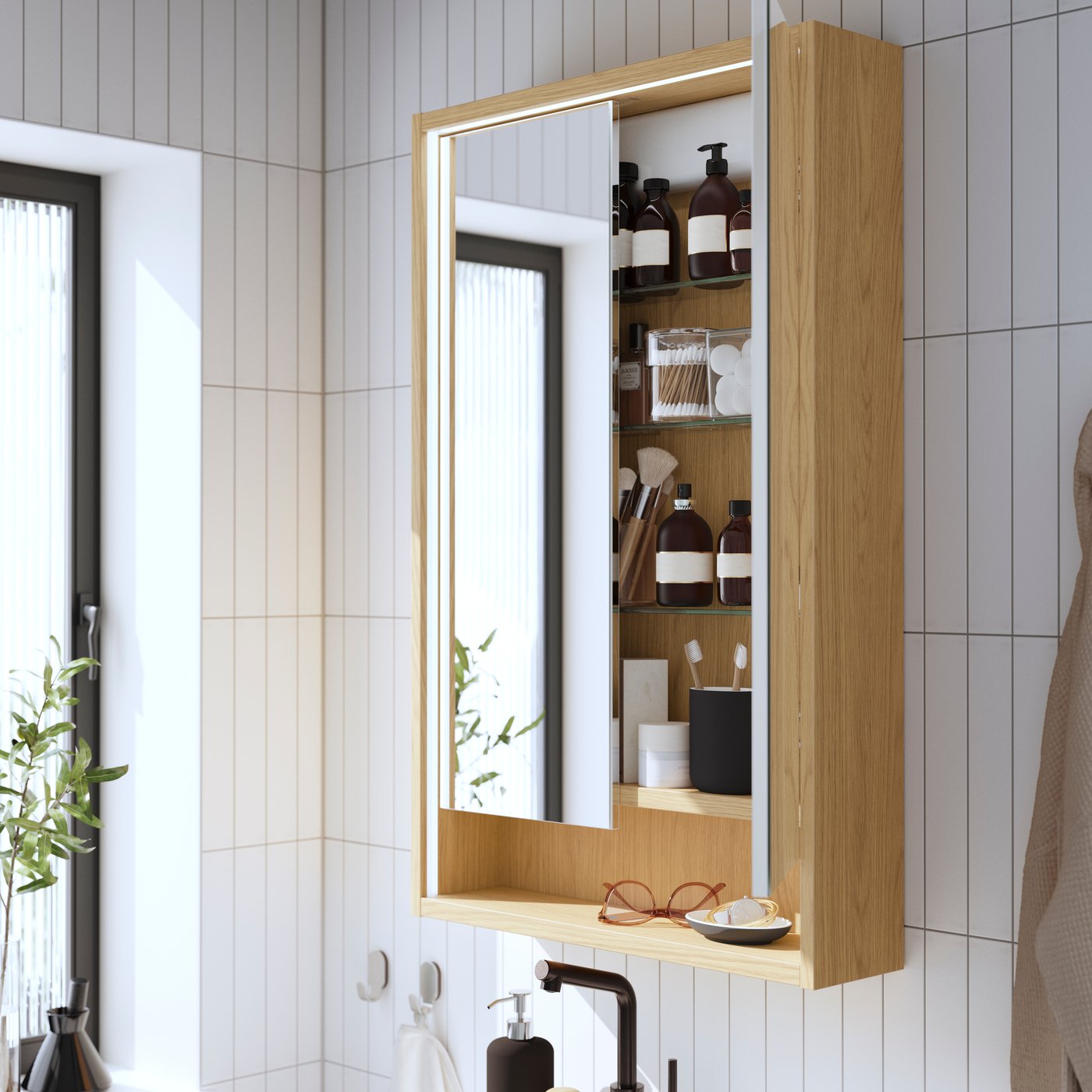 An oak effect FAXÄLVEN mirror cabinet w built-in lighting