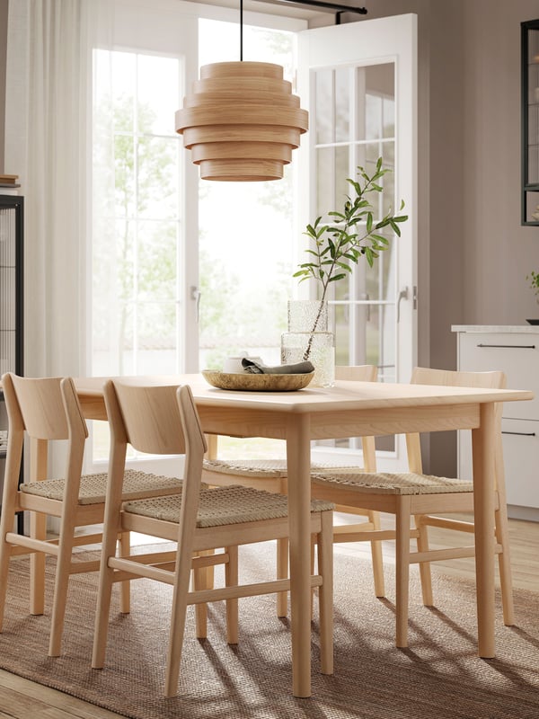 A light beech/veneer SKANSNÄS extendable table in the dining room