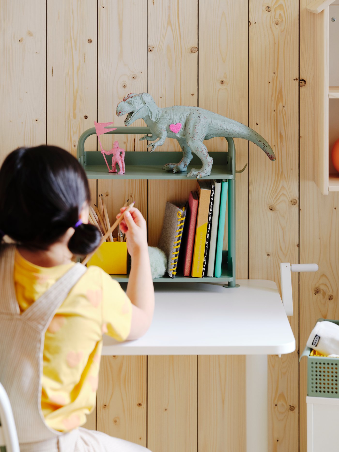 A white/light grey-green RELATERA desk combination sit/stand in the childrens room