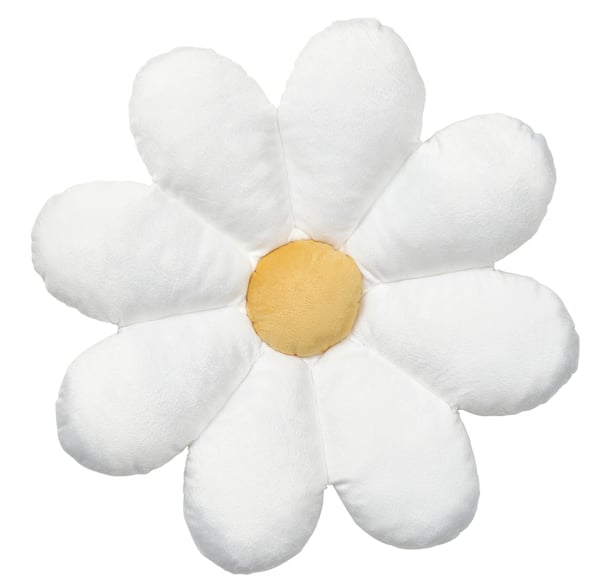 A flower-shaped/white SKOGSDUVA cushion in the NA