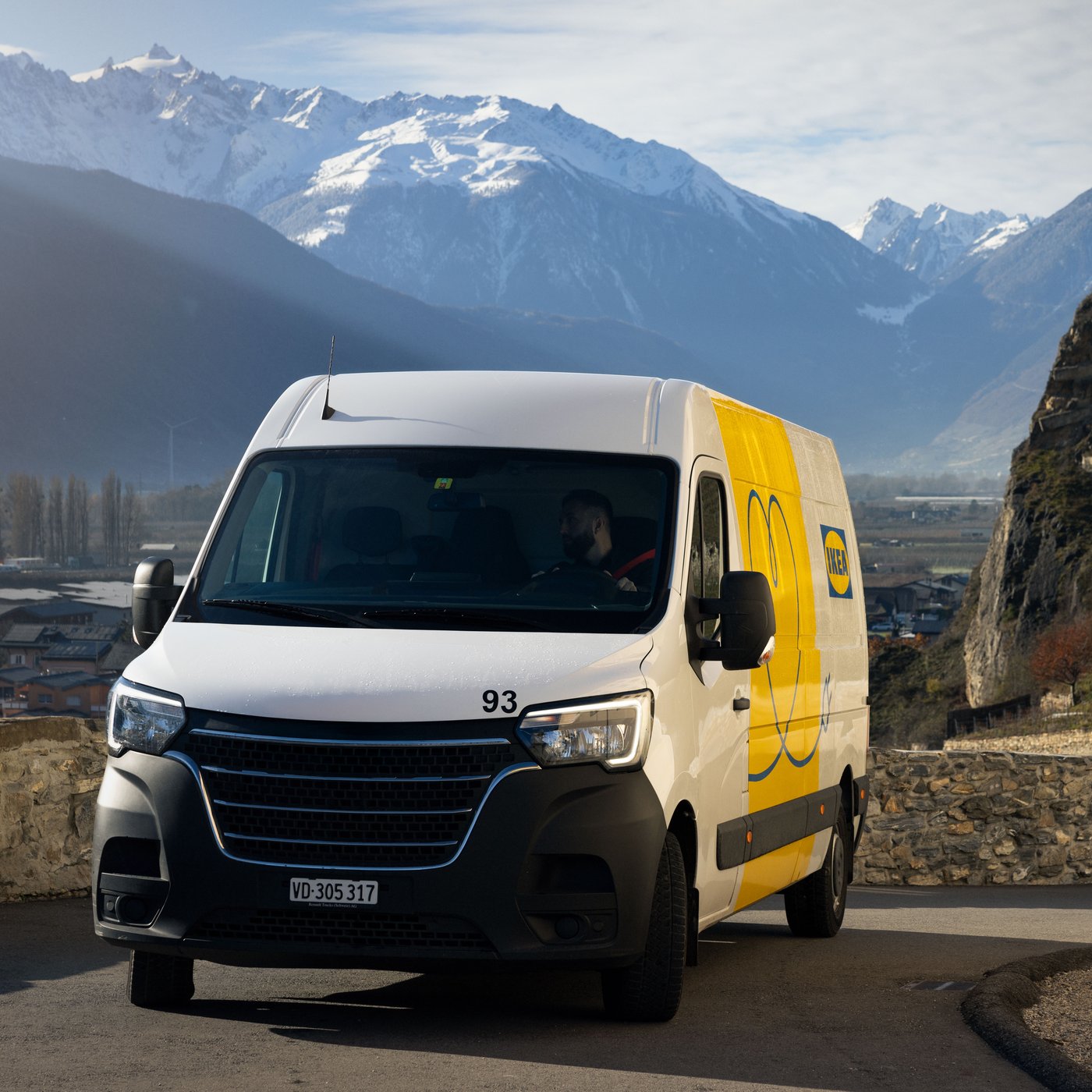 An IKEA rental van in front of a mountain landscape in Switzerland.