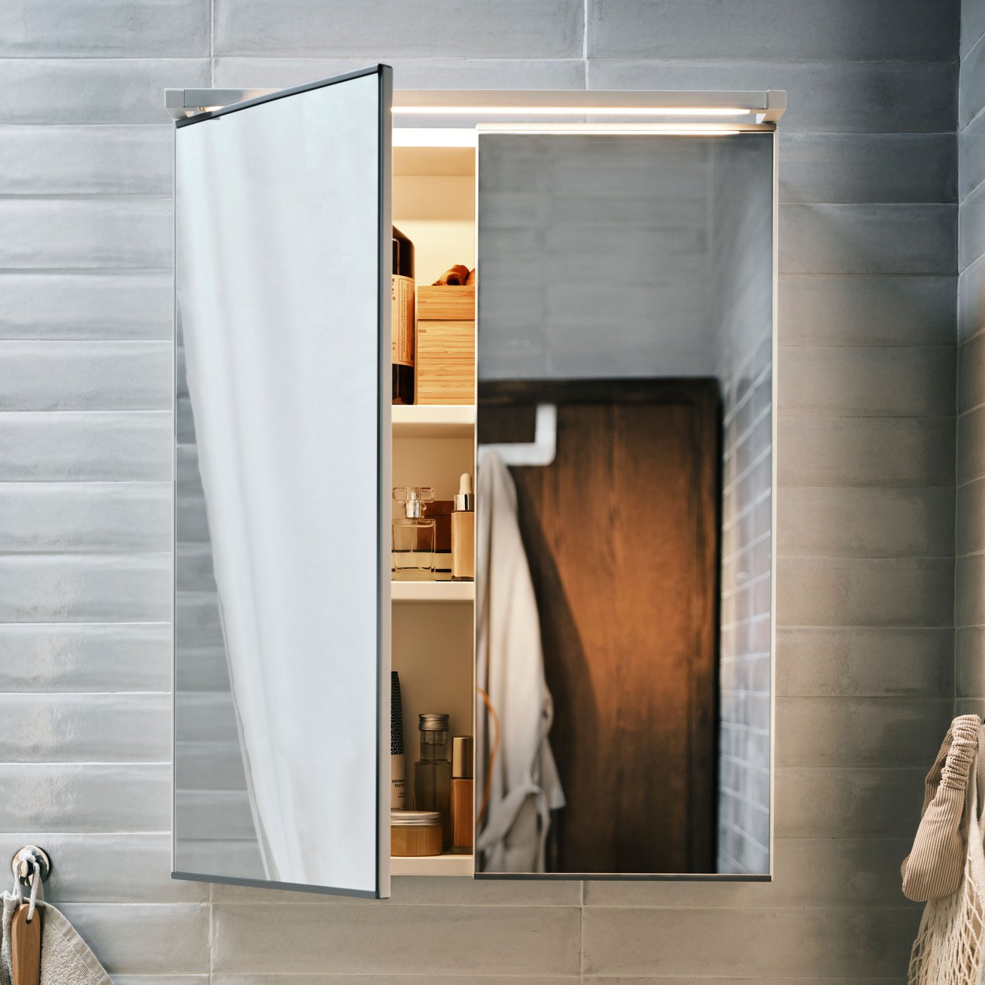 A white ENHET mirror cabinet with 2 doors in the bathroom
