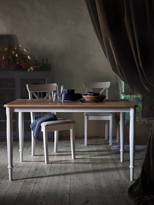 Elegant dining room with 4 seat dining table with hardwood veneer top layer and tubular steel legs, and matching chairs.