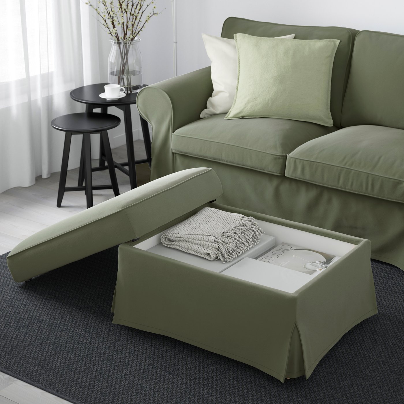 A Hakebo grey-green UPPLAND footstool with storage in the living room