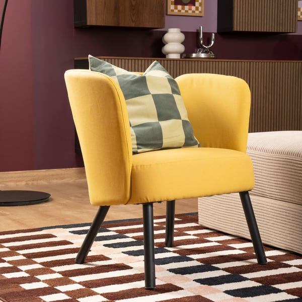A Diseröd dark yellow HERRÅKRA armchair in the living room