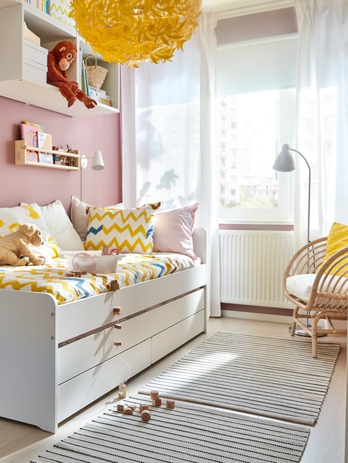Bedroom with bed frame with underbed, armchair, quilt cover, pillowcase, floor lamp, rug, wall storage, LED wall lamp, toys.