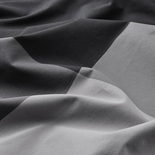 A black BRUNKRISSLA duvet cover and pillowcase