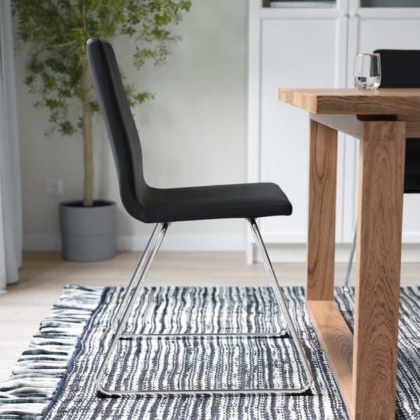 A chrome-plated/Bomstad black LILLÅNÄS chair in the dining room