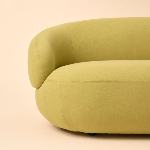Part of a bright-green-yellow LILLESÄTER three-seat sofa, placed against a pale-yellow background.