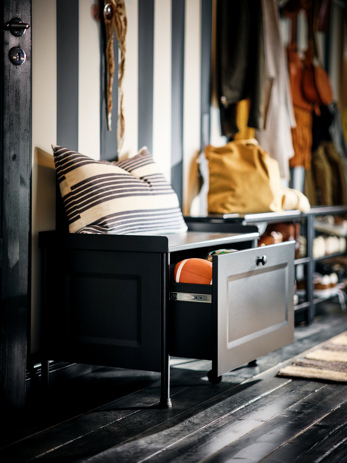 A black KORNSJÖ storage bench