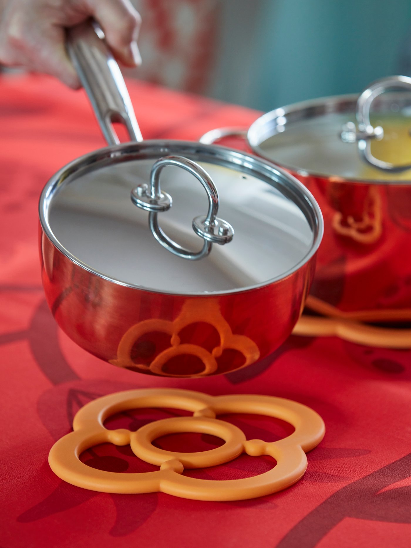 An orange FÖSSTA pot stand