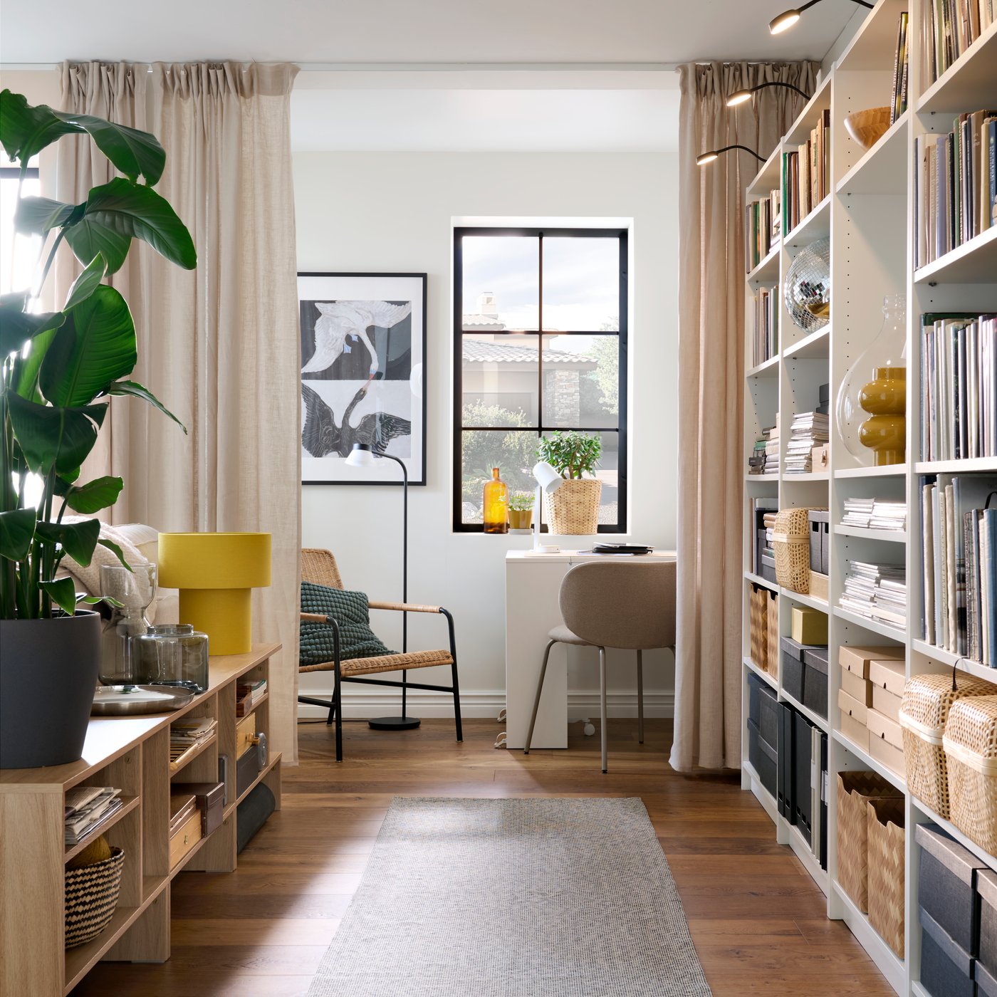 Part of a bright living room framed by HOLMERUD side tables and BILLY bookcases fitted with YTBERG LED cabinet lighting.