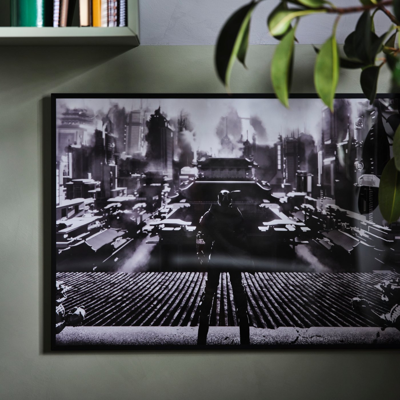 An UPPSPEL poster on a grey wall with the corner of a shelf in the top left and the green leaves of a plant on the right.