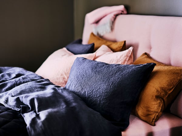 A dark grey DYTÅG duvet cover and pillowcase