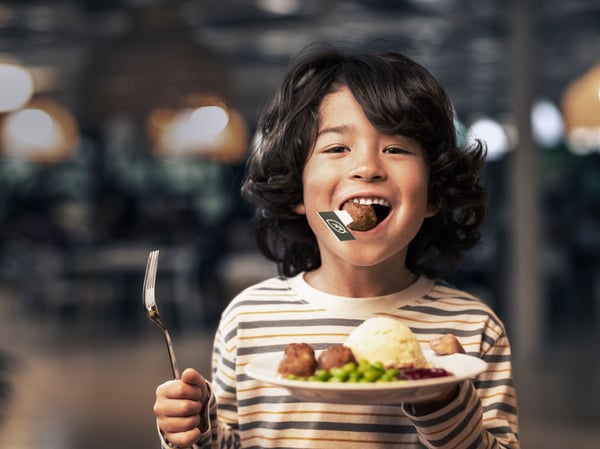 child eating meatballs at the IKEA restaurant